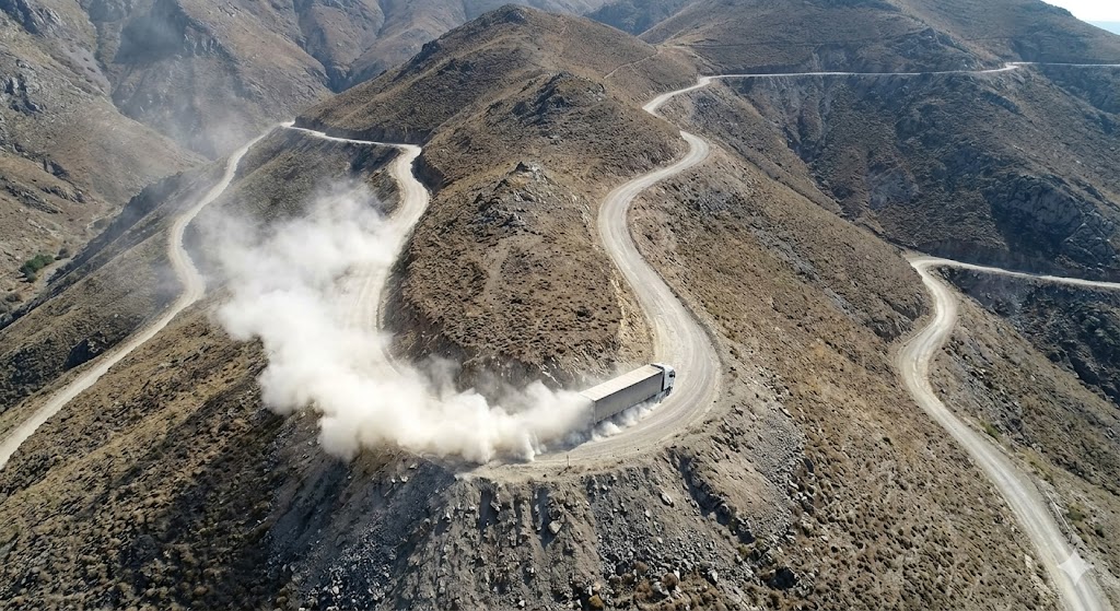 Dusty and winding Patiopoulo-Perdikaki dangerous mountain road without guardrails in Greece.